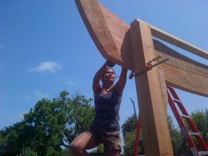 Student Isabelle attaches the crosspiece over the garden entrance
